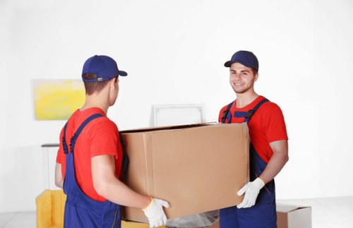 Movers carrying furniture from a flat in Denmarkhill