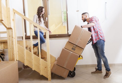 Removal team navigating stairs and access challenges in a Denmarkhill property